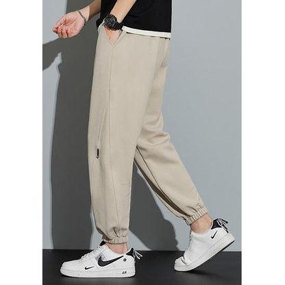 Pantalón de chándal holgado con cordón ajustable, tejido de punto y color sólido.
