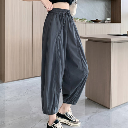 Pantalon ample à taille haute affinant, à jambes larges et à coupe fuselée décontractée de poids moyen.