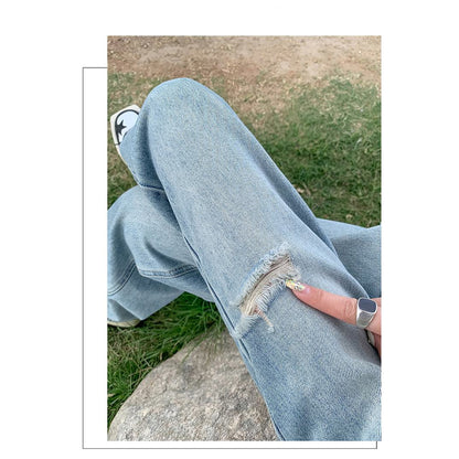 Distressed Jeans in bodenlanger Länge mit Stickerei