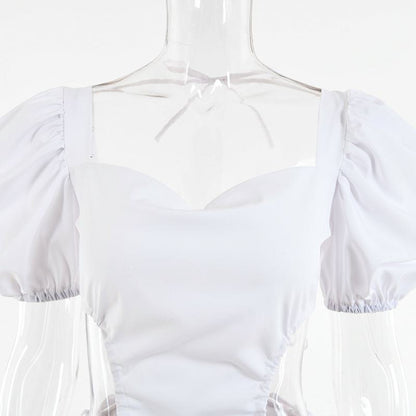 Vestido de manga abombada y espalda descubierta con lazo ajustable, de tela elástica en cuatro direcciones.