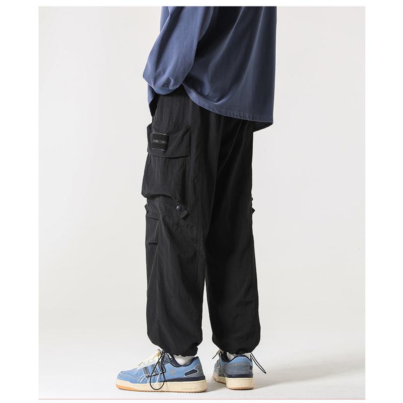 Pantalones casuales elásticos y versátiles con bolsillos cónicos y a prueba de agua