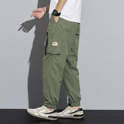 Pantalon fuselé à fermeture éclair et poches multiples élastiques