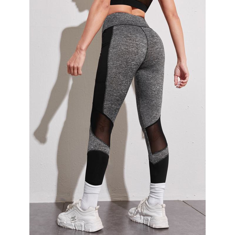 Leggings deportivos ajustados con bolsillo para entrenamiento de yoga y running con malla de parches.