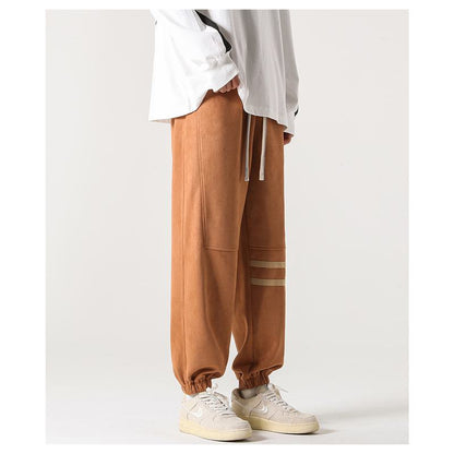 Pantalon de sport polyvalent à taille élastique en similicuir velouté.