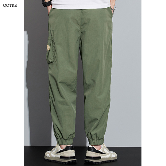 Pantalones cónicos con cremallera de múltiples bolsillos elásticos