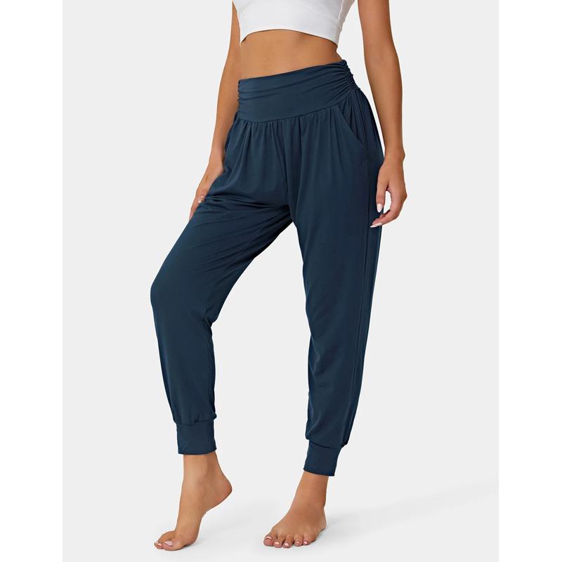 Pantalones deportivos holgados con cintura alta, bolsillos casuales, cordón ajustable y pliegues para yoga.