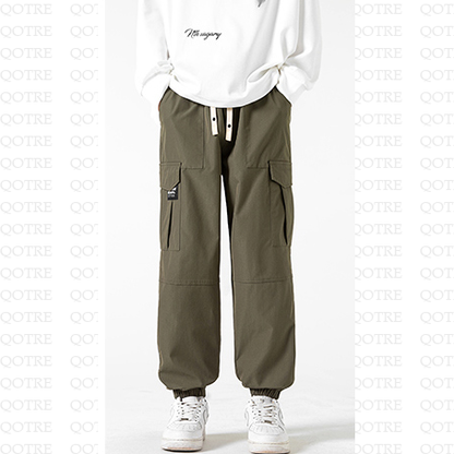 Pantalones cónicos de estilo urbano con elasticidad, ajuste holgado, bolsillos plisados y sólidos.