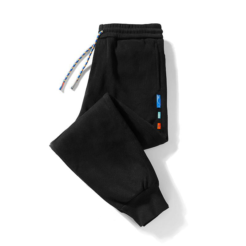 Pantalon en coton pur à taille élastique, coupe ample et fuselée, épais et polyvalent, avec élasticité.