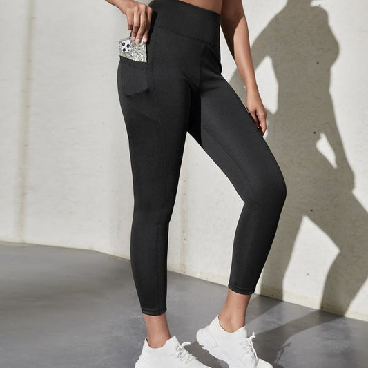 Leggings deportivos ajustados de cintura alta con bolsillo para yoga y carrera.