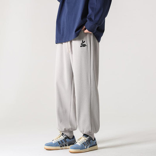 Pantalon de survêtement ample en tricot tendance, droit et polyvalent.