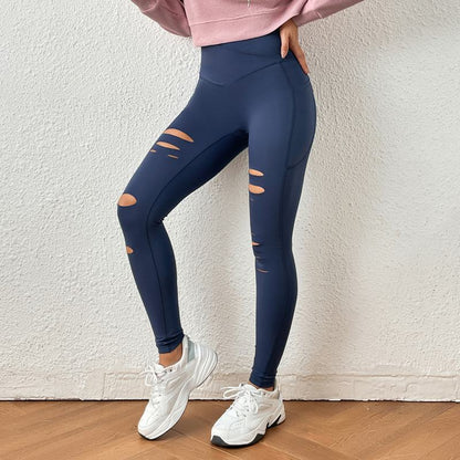 Pantalones deportivos ajustados y elásticos con efecto desgastado y realce de glúteos para yoga y fitness.