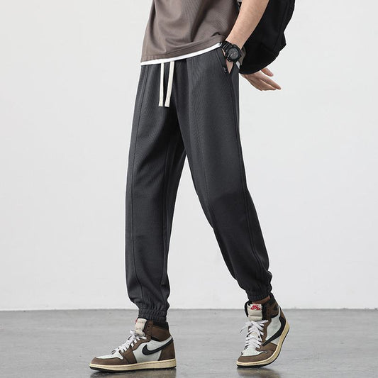 Pantalón deportivo holgado de ajuste elástico a cuadros de espiga de moda