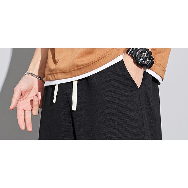 Pantalón de chándal holgado con cordón ajustable, tejido de punto y color sólido.