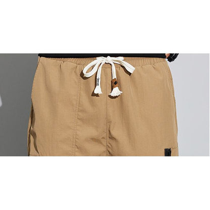 Pantalones cónicos con cremallera de múltiples bolsillos elásticos