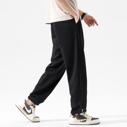 Pantalón de deporte casual de punto versátil y moderno con tobillo suelto y cordón ajustable.