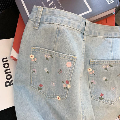 Jupe en jean moulante à taille haute avec imprimé floral et broderie rétro.