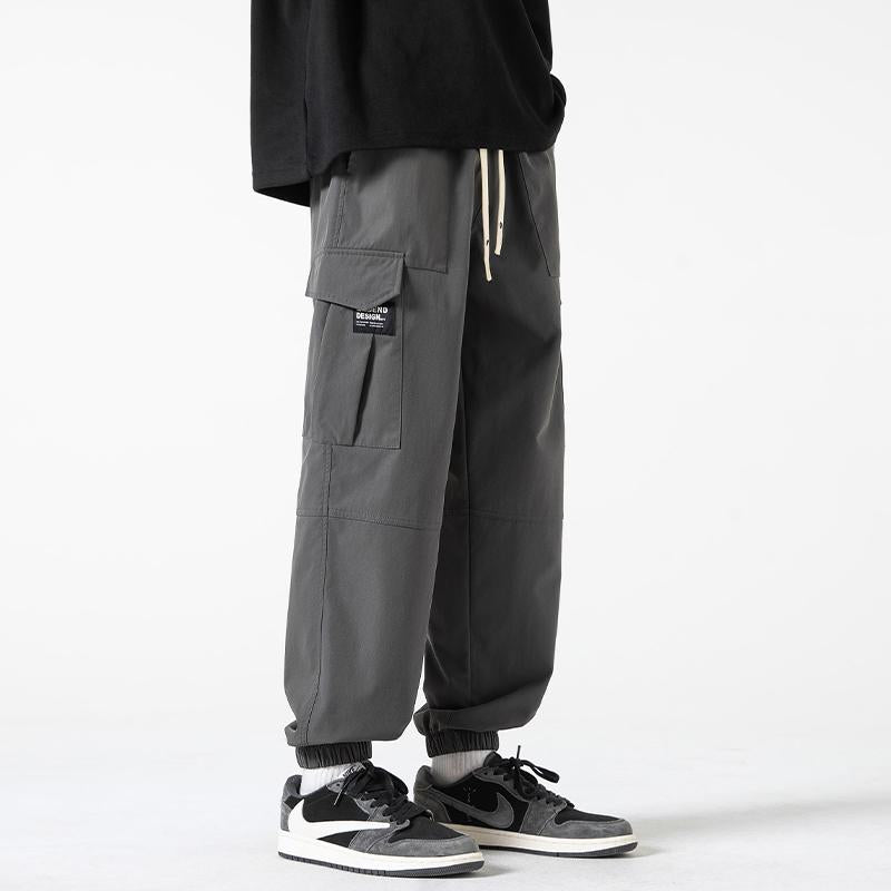 Pantalones cónicos de estilo urbano con elasticidad, ajuste holgado, bolsillos plisados y sólidos.