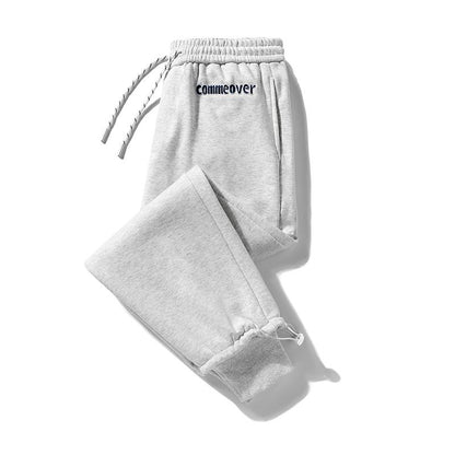 Pantalón de algodón puro versátil con cintura elástica y ajuste holgado de talle cónico y bordado