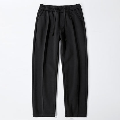Pantalon ample en tricot confortable à taille élastique, coupe droite polyvalente et élastique.