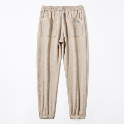 Pantalones cónicos de ajuste holgado con cintura elástica y elasticidad delgada.