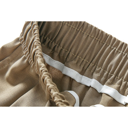 Short en soie glacée de couleur unie, taille haute, jambes larges et coupe ample à cordon.