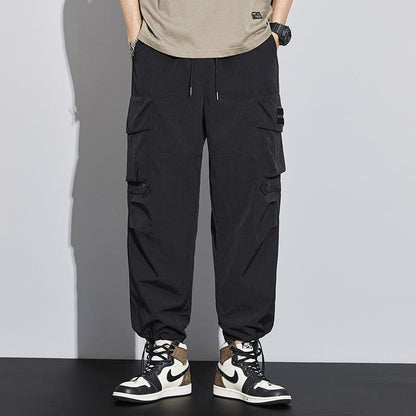 Pantalones cargo versátiles impermeables con bolsillos de tendencia de pierna recta y ancha con elasticidad.