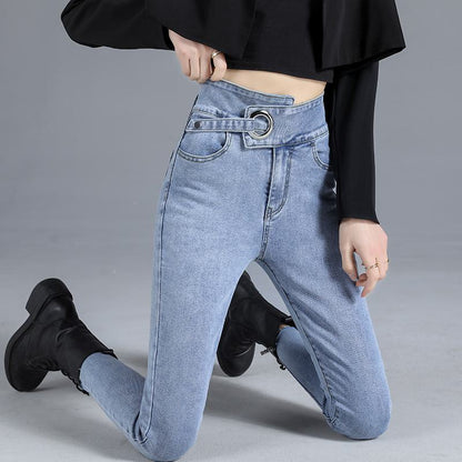 جينز ضيق من اللون الفاتح بخصر عالي يشد الجسم ويمنحه شكلاً نحيلًا.