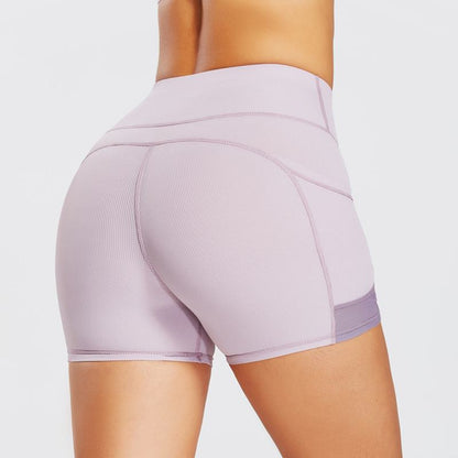 Pantalones cortos deportivos ajustados de yoga de cintura alta con bolsillo ultra cortos y acanalados para fitness.