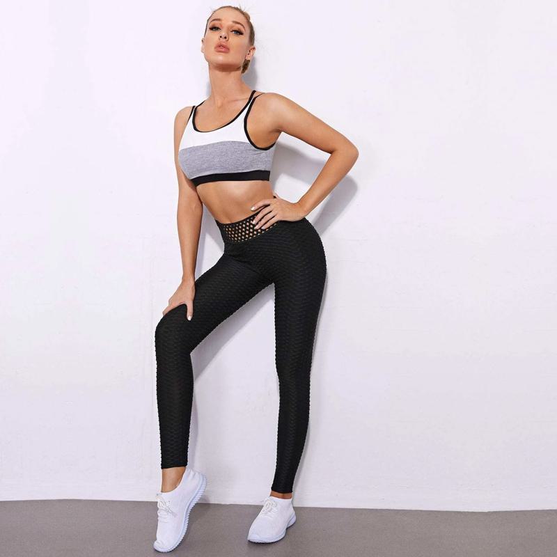 Leggings deportivos de jacquard elástico de yoga de cintura alta con patrón de tejido calado para deportes y fitness.