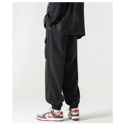 Pantalones cónicos con bolsillo con cremallera y elasticidad