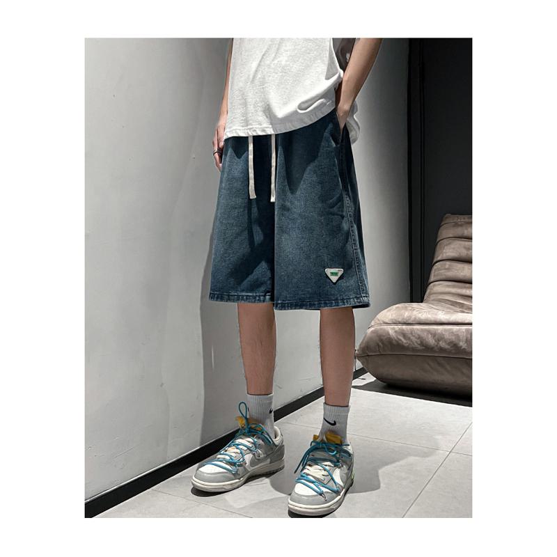 Pantalones cortos de mezclilla de moda, sueltos y versátiles con cintura elástica y cordón ajustable.