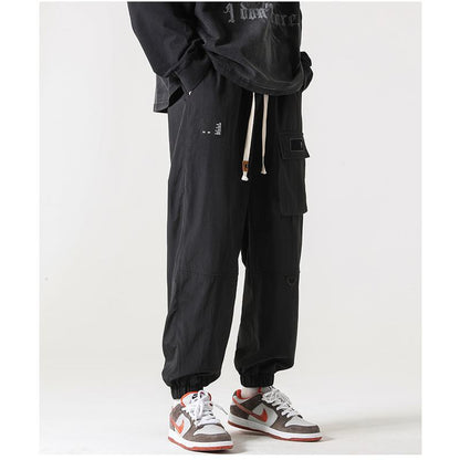 Pantalones cónicos con bolsillo con cremallera y elasticidad